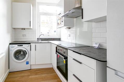 Bright and modern kitchen featuring sleek white...