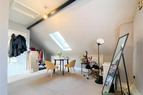 Bright and airy master bedroom featuring a cozy...