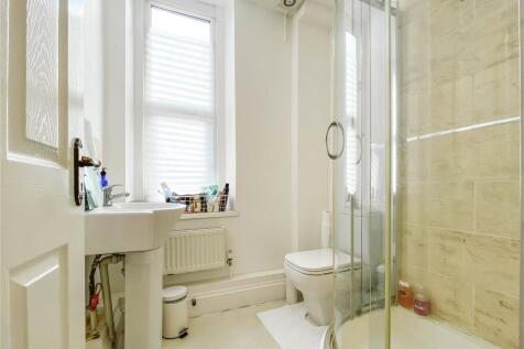 Bright and modern bathroom suite featuring a sp...