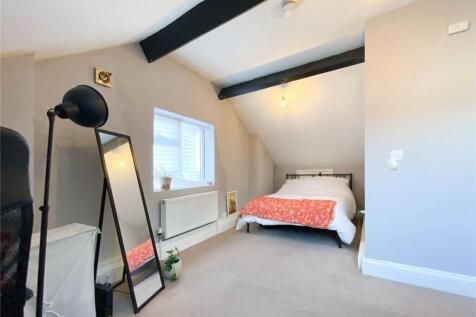 A bright and tidy double bedroom featuring a co...
