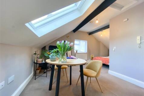 Bright and cozy double bedroom featuring a skyl...