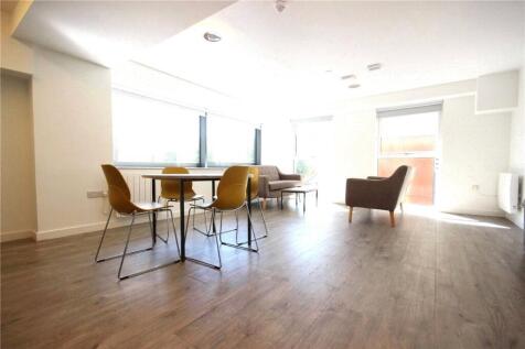 Bright and modern living room with ample natura...