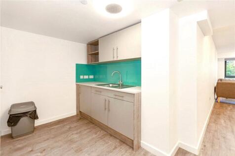 Bright and modern kitchen area with clean count...
