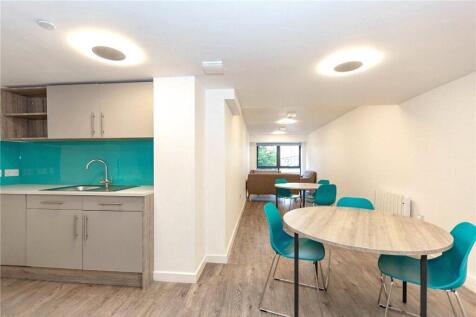 Bright and modern kitchen and dining area featu...