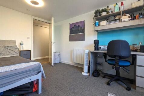 A tidy and well-organized bedroom featuring a c...