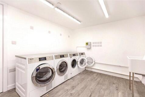 Bright and clean laundry room with multiple mod...