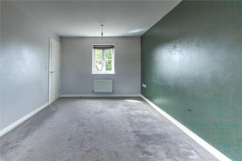 A bright double bedroom featuring a large windo...