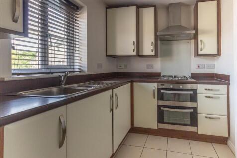 A clean and well-lit kitchen featuring ample ca...