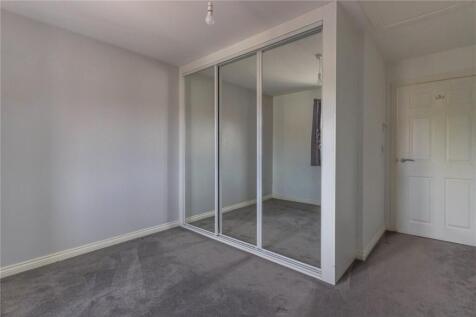A clean and neutral double bedroom featuring a ...