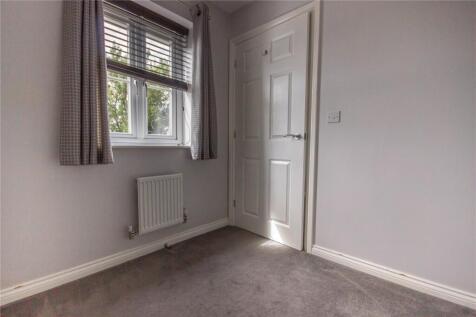A neat and tidy small toilet room with a window...