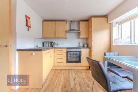 Bright and modern kitchen featuring ample natur...