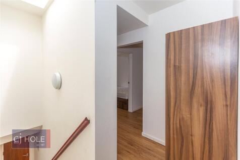 A clean and well-maintained hallway featuring w...