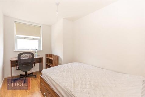 A clean and bright single bedroom featuring a c...