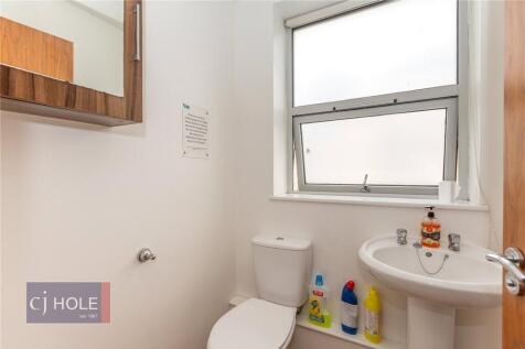 Bright and clean single toilet room featuring a...