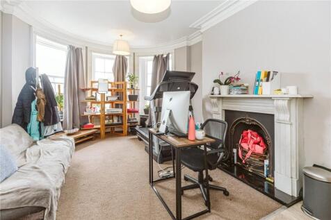A bright and inviting living room featuring a c...