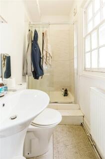 Bright and clean bathroom featuring a white bas...