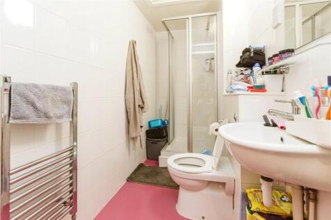 Bright and tidy bathroom featuring modern white...