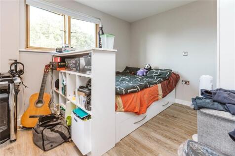 Cozy single bedroom featuring a well-organized ...