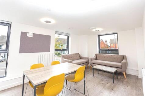 Bright and modern living room featuring comfort...
