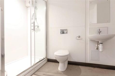 Bright and modern bathroom featuring a large sh...