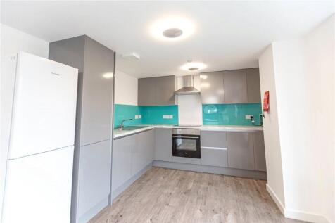 A modern kitchen featuring sleek grey cabinetry...