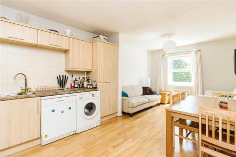 Bright and modern kitchen featuring light wood ...