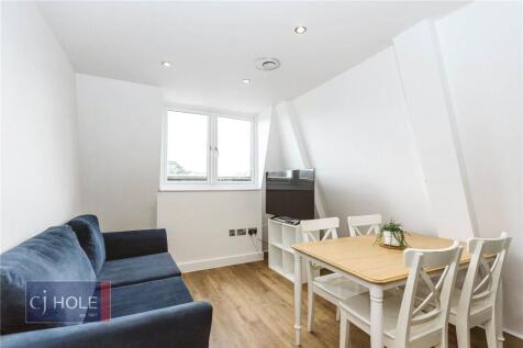 Bright and neatly arranged living room featurin...