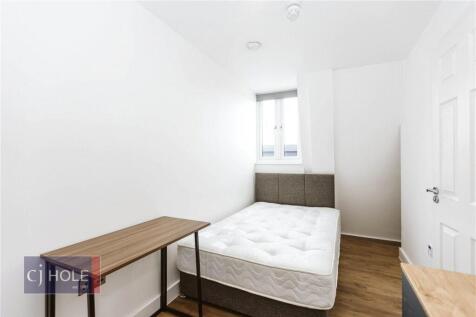 A clean and simple double bedroom featuring a c...