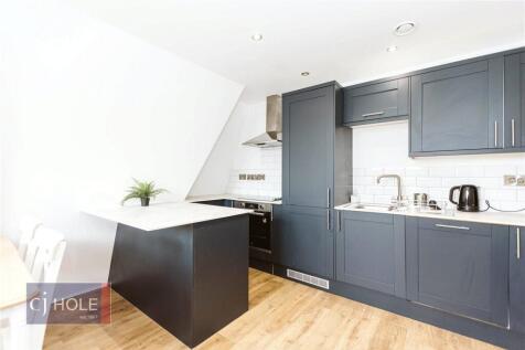Modern kitchen with sleek grey cabinetry, a spa...