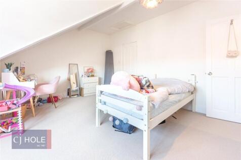Bright and airy master bedroom featuring a comf...