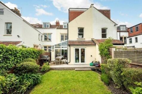 A well-maintained, spacious garden with lush gr...