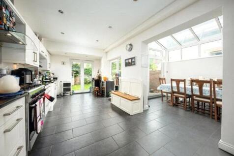 Bright and spacious kitchen featuring sleek mod...
