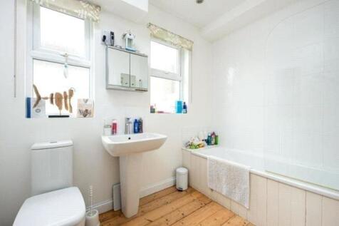 Bright and clean bathroom featuring a white bat...