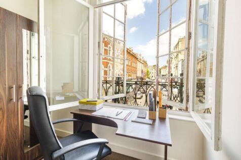 Bright and inviting communal workspace featurin...