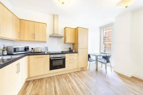 Bright and modern kitchen featuring light woode...