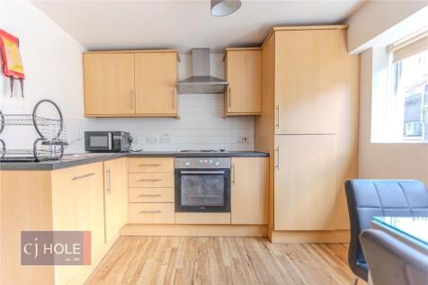 Bright and tidy kitchen with modern wooden cabi...