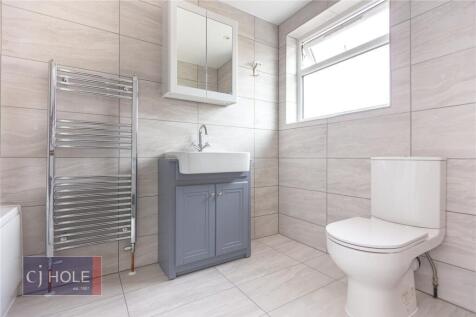 Bright and modern bathroom suite featuring larg...
