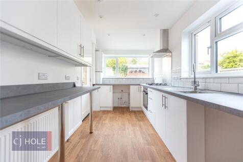 Bright and modern kitchen with ample counter sp...