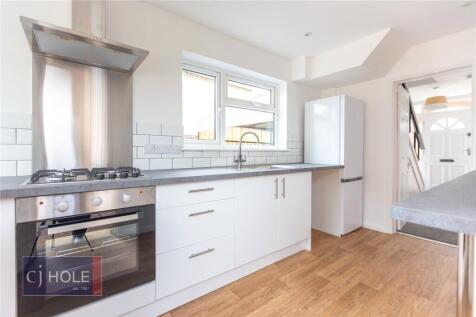Bright and modern kitchen featuring sleek white...