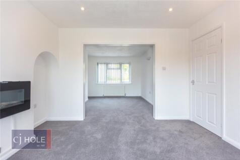 Bright and spacious living room featuring neutr...