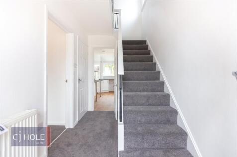 Bright and clean hallway featuring a modern sta...