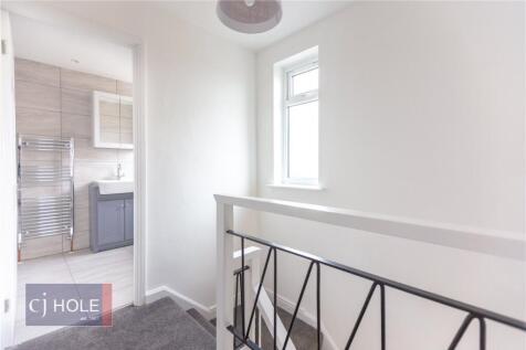 Bright and clean hallway featuring a decorative...