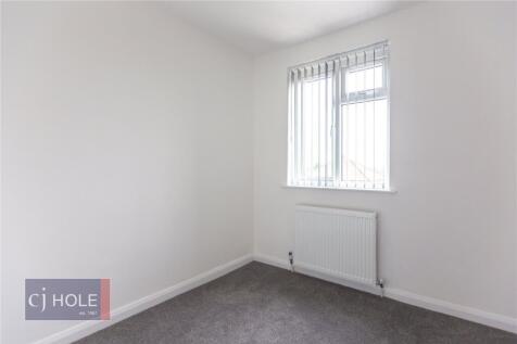 A clean and bright single bedroom featuring neu...