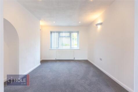 A bright and clean small room with neutral whit...