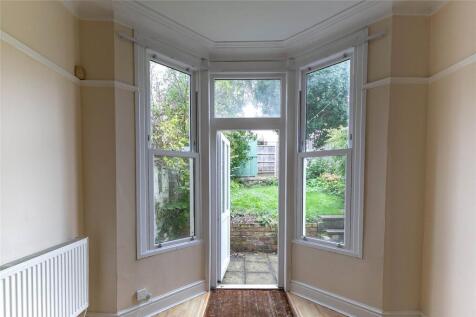 Bright and welcoming hallway featuring large ba...
