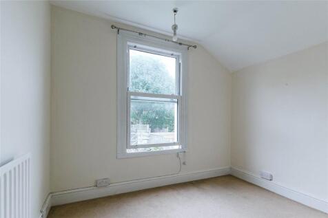 A clean and bright empty room featuring a large...
