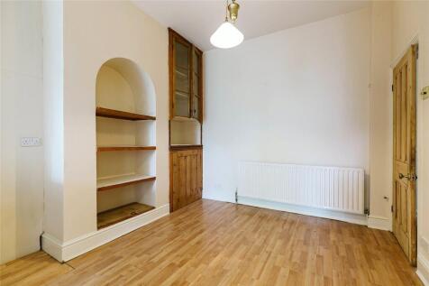Bright and clean single bedroom featuring woode...