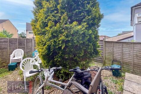 A charming and private garden space featuring a...
