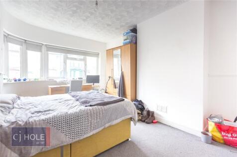 Bright double bedroom featuring a large bay win...