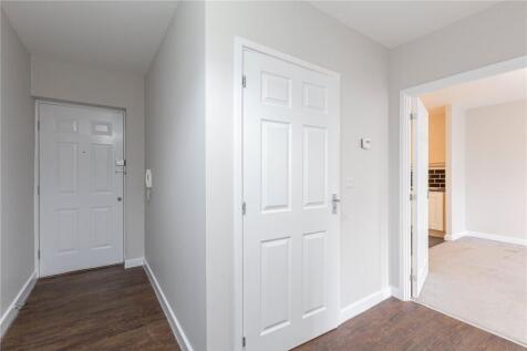 Bright and clean hallway featuring white walls ...